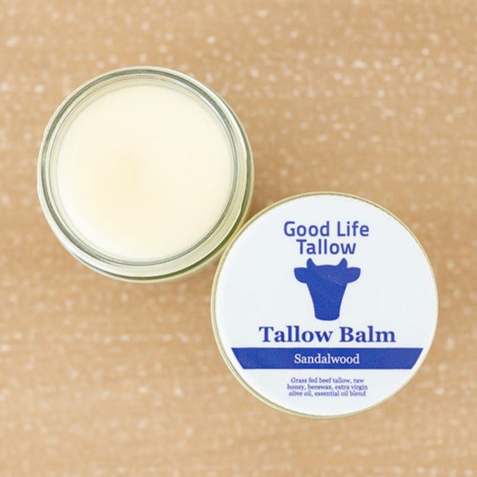 a jar of tallow balm showcasing the smooth texture and application