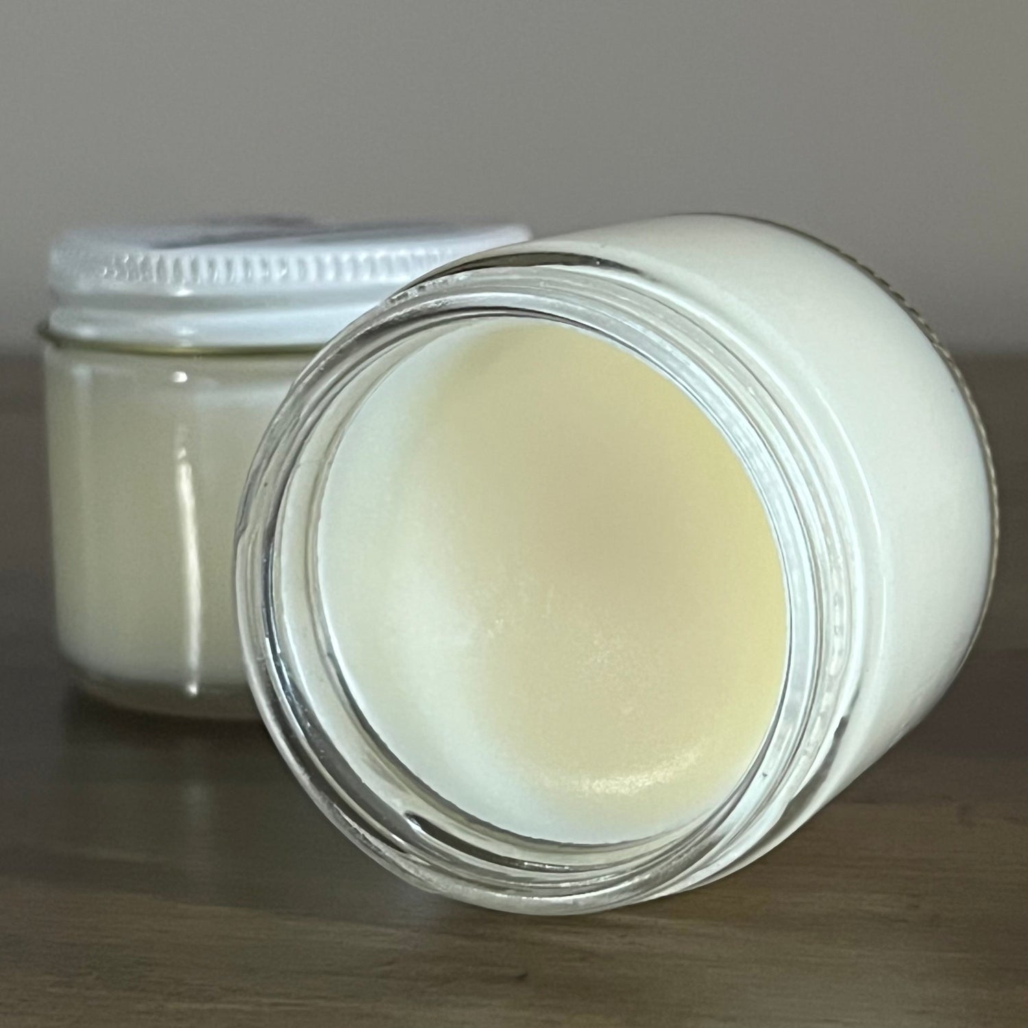 grass fed tallow balm jar showcasing smooth texture and application